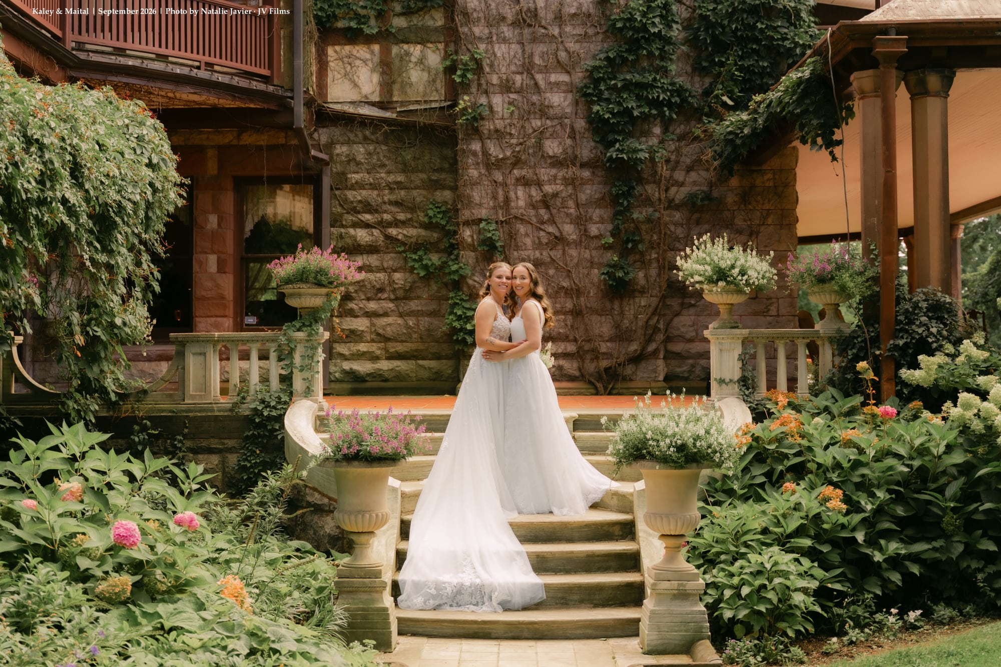 Brides embracing on the stone terrace at Sonnenberg Gardens