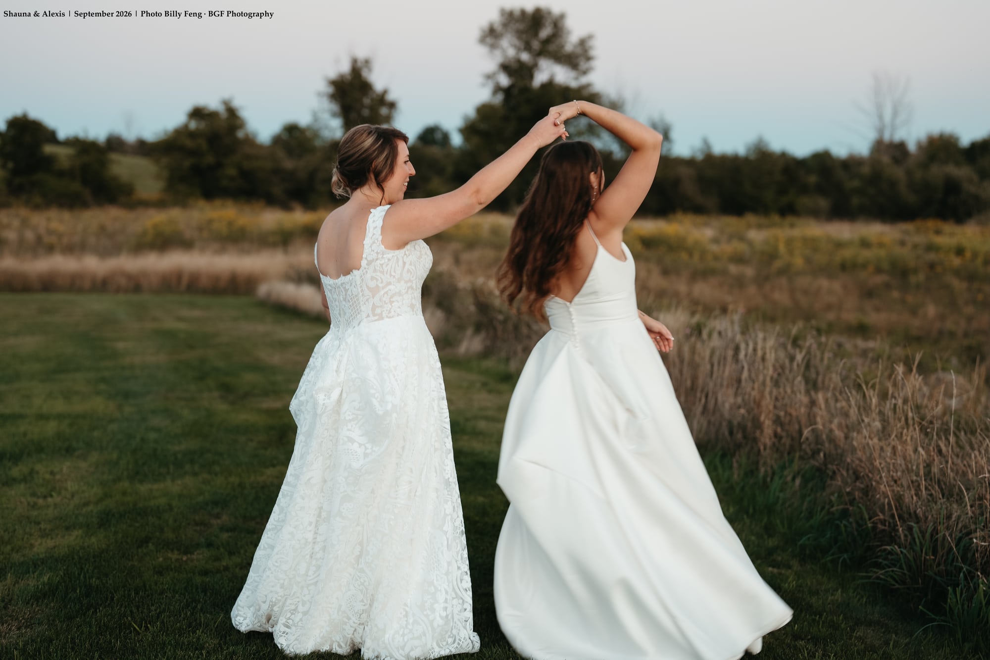 Shauna and Alexis dancing in the meadow at twilight