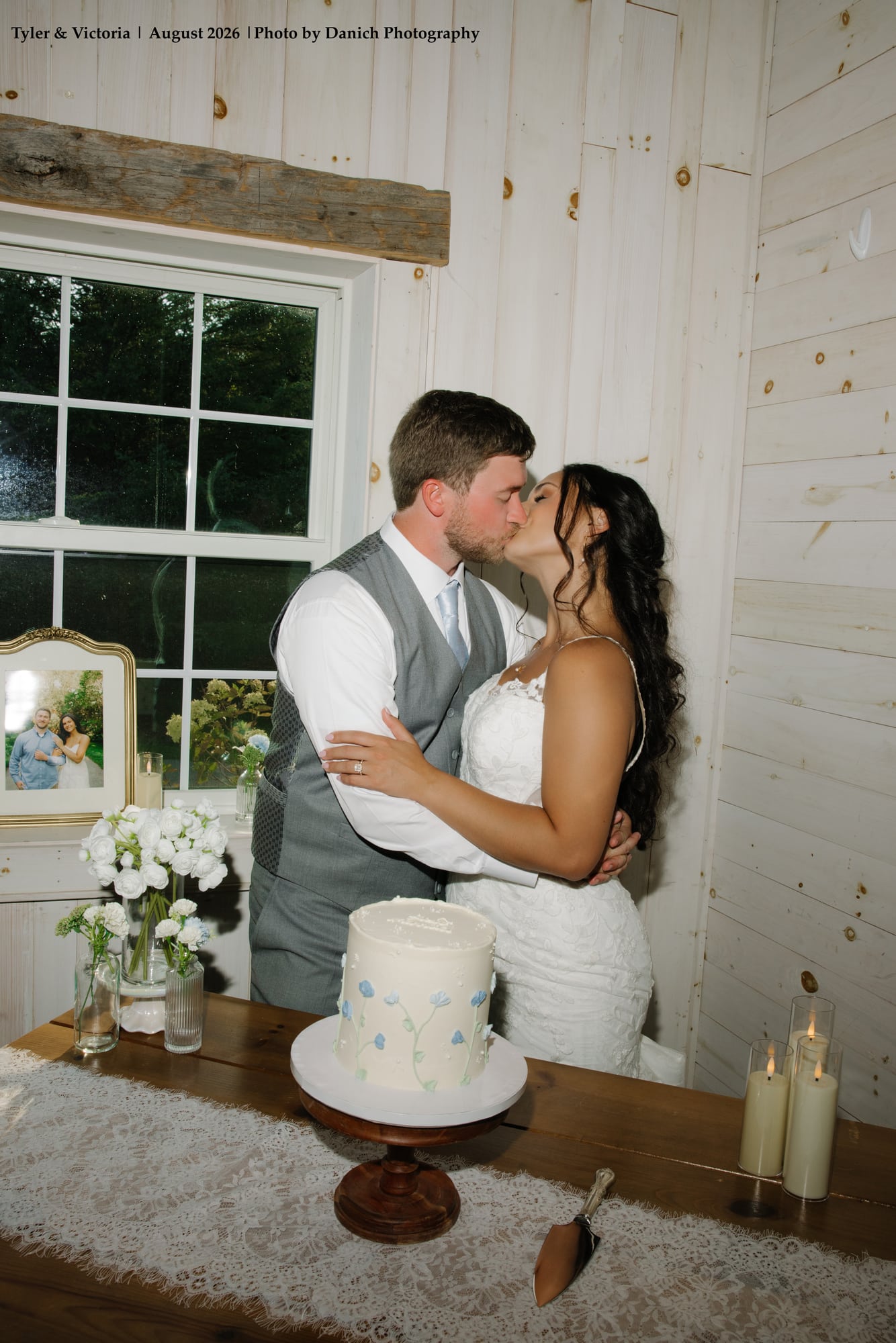 Newlywed bride and groom romantic kiss in barn window