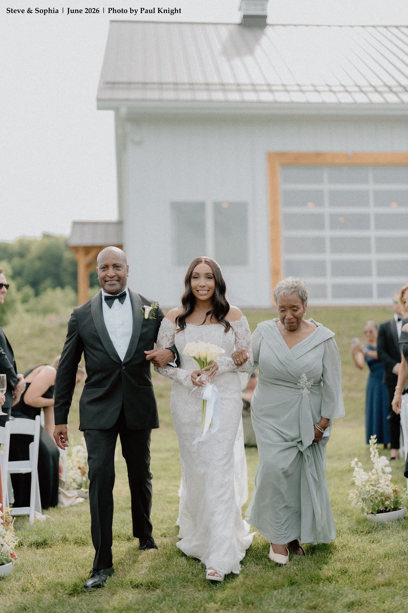 Bride Sophia walking down the aisle with her family