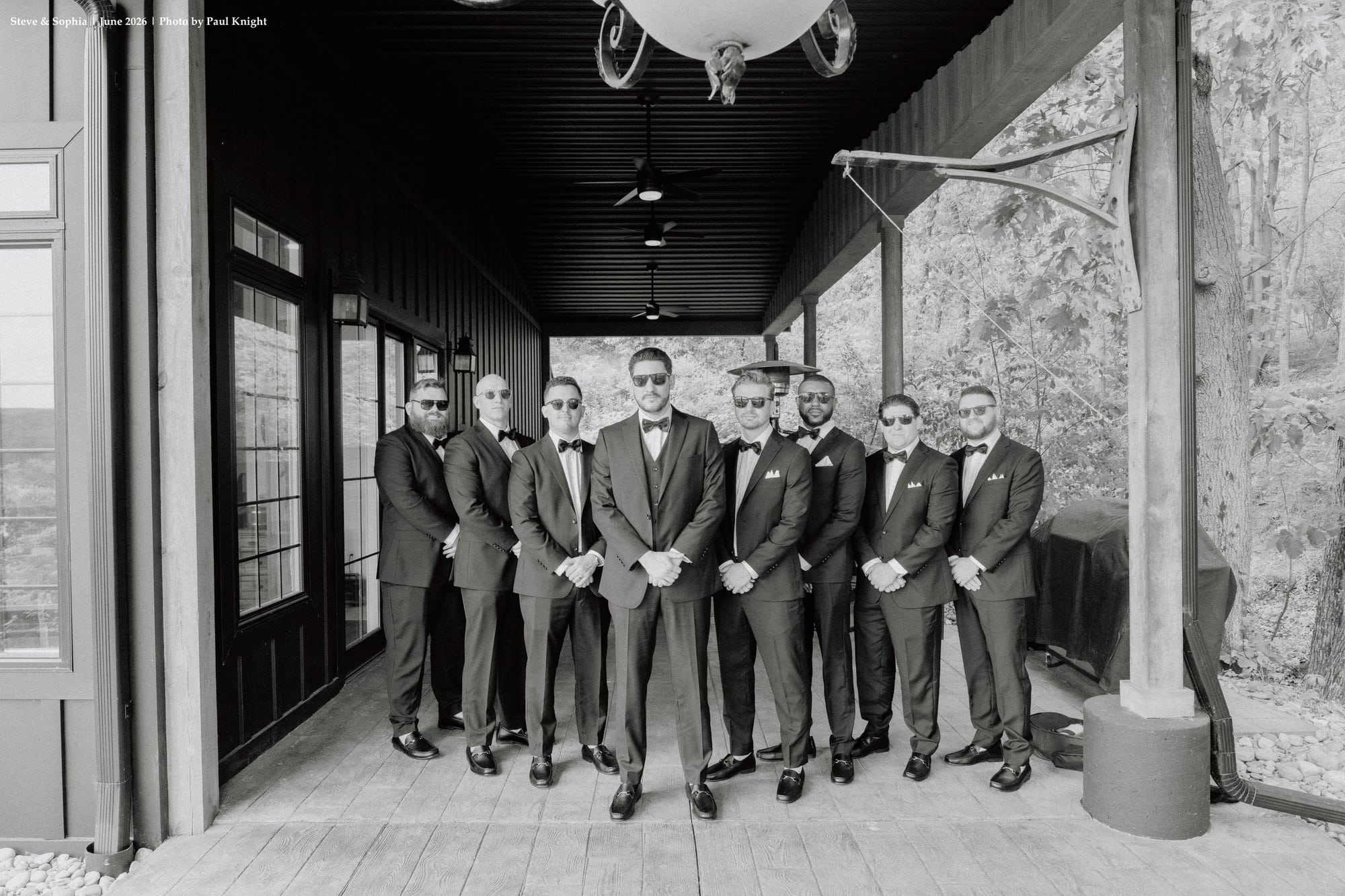 Groom and groomsmen gathered on the covered veranda